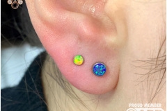 First and Second Ear Lobe Piercings w/ Opals. Inkhaus Tattoo.