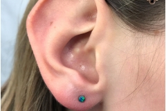 Ear Lobe Piercing w/ NeoMetal Peacock Opals. Inkhaus Tattoo.