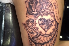 Greyscale pocket watch with rose and fishnet.