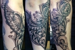 Greyscale crow skull with acanthus and jewellery.