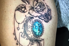 Turquoise jewel with greyscale rose and butterfly.