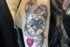 Greyscale pocket watch with red heart jewel and acanthus.
