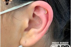 Helix piercing w/ anatometal rose gold moon.