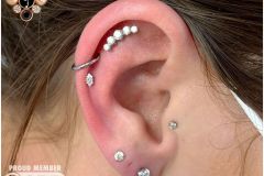 Helix piercing w/ anatometal white gold marquise prong.