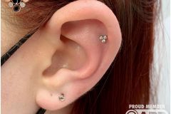 Helix piercing w/ neometal trinity cluster.