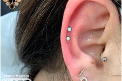Double helix piercing w/ neometal white opals.