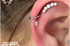 Helix piercing w/ anatometal white gold marquise prong.