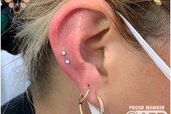 Double helix piercing w/ neometal clear CZs.