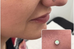 Nose piercing with 2.5mm NeoMetal white opal. Inkhaus Tattoo.