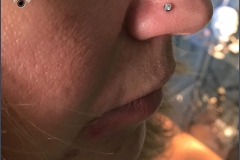 Nose piercing with 2.5mm NeoMetal CZ. Inkhaus Tattoo.
