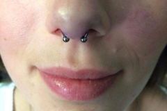 Septum Piercing with Circular Barbell. Inkhaus Tattoo.
