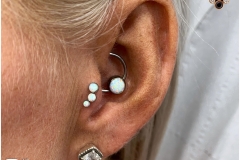 Tragus w/ Anatometal Opal Cluster. Inkhaus Tattoo.